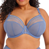 Woman wearing a blue bra and underwear set on a white background