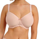 Woman wearing a light pink bra and underwear set on a white background