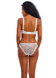 Woman wearing a white lace lingerie set on a white background