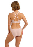 Woman wearing a light pink bikini set on a white background