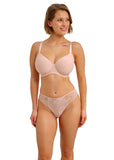 Woman wearing a pink bra and panties set on a white background