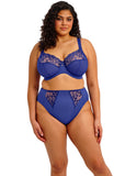 Woman wearing a blue lingerie set with lace details on a white background