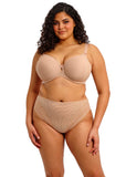 Woman wearing a beige bra and panties set on a white background