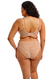 Woman wearing a beige shapewear set on a white background
