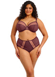 Woman wearing a burgundy lingerie set on a white background