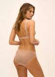 Model is wearing nude coloured bralette with cream floral lace