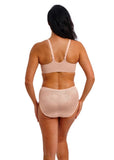 Woman wearing a beige bra and underwear set on a white background