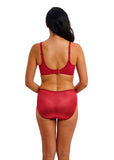 Woman wearing a red bra and underwear set on a white background