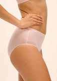 Person wearing light pink underwear on a beige background