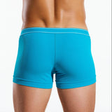 Blue boxer briefs worn by a person on a white background