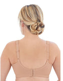 Woman wearing a beige back support brace on a white background