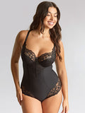 Woman wearing a black lace bodysuit against a plain background