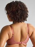 Person wearing a pink bra against a gray background