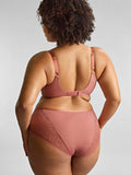 Person wearing a pink lingerie set on a plain background
